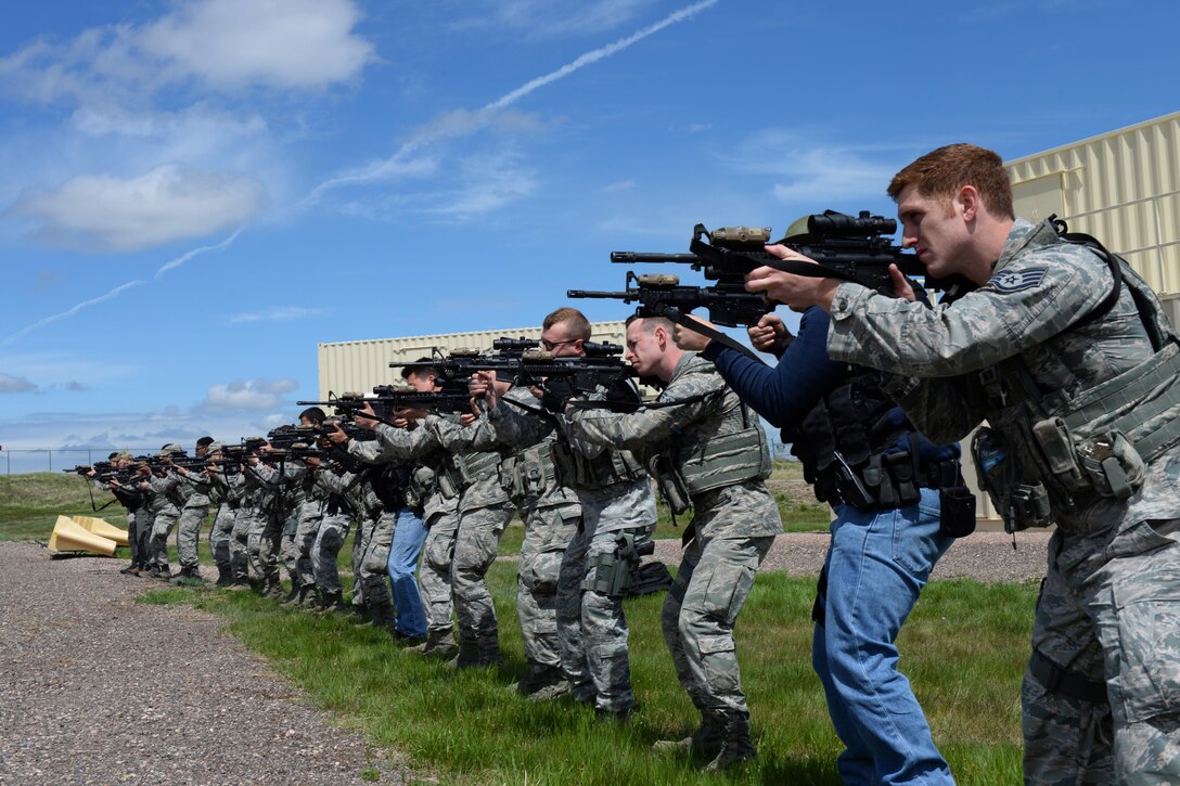28th Security Forces Squadron personnel participate in an annual training event to hone their group tactical skills at Ellsworth Air Force Base, S.D., May 9, 2017. Airmen participated in group exercises which focused on reviewing different formations for tactical movement, workplace violence de-escalation via non-lethal and lethal means, an active shooter exercise and a “quick draw” event that involved simulating a wounded support hand. (U.S. Air Force photo by Airman Nicolas Z. Erwin)
