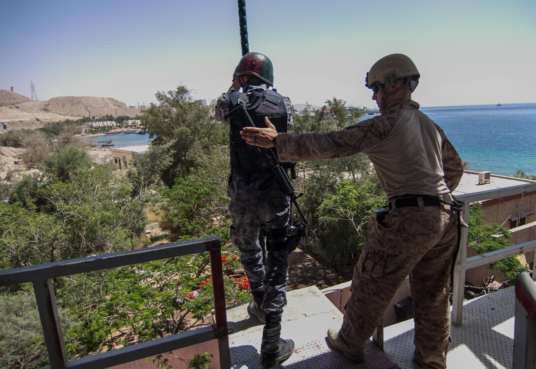 A U.S. Marine assists the Jordanian Navy in a fast rope exercise during Eager Lion 2017.  Eager Lion is an annual U.S. Central Command exercise in Jordan designed to strengthen military-to-military relationships between the U.S., Jordan and other international partners. This year's iteration is comprised of about 7,200 military personnel from more than 20 nations that will respond to scenarios involving border security, command and control, cyber defense and battlespace management.  (U.S. Army photo by Sgt. Mickey A. Miller)