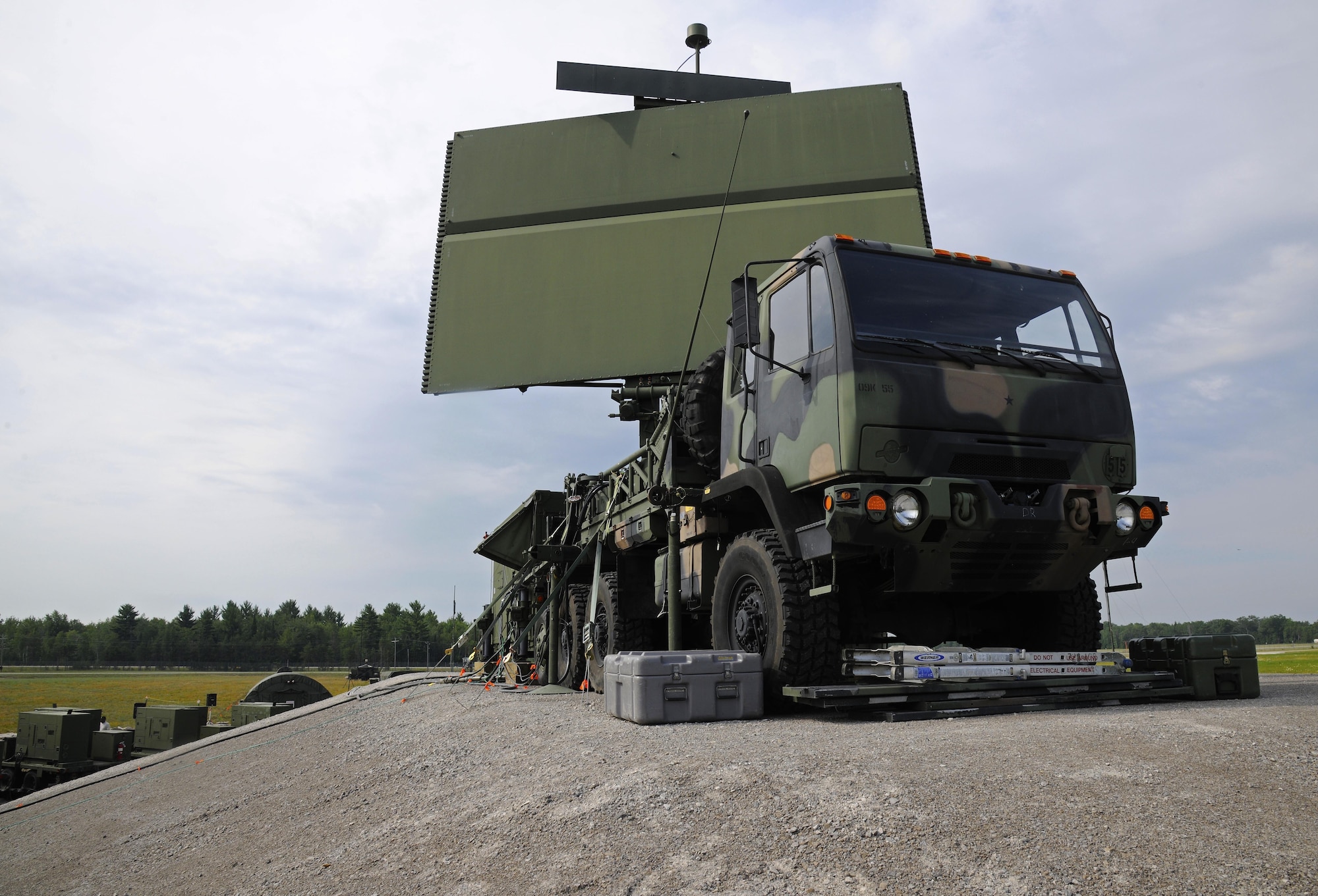 A AN/TPS-75 radar rests on the back of a transport vehicle at the Alpena Combat Readiness Training Center, Mich., July 29, 2015. The AN/TPS-75 radar is capable of providing coverage of more than 200 nautical miles in every direction and detecting aircraft as high as 95,000 ft. Following release of a contract award May 11, 2017, the radar, dating to the Vietnam War era and containing vacuum tube technology, will be replaced by Raytheon Co. built three dimensional expeditionary long-range radars by 2028.  (U.S. Air National Guard photo by Senior Airman Ryan Zeski/Released)