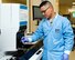 U.S. Air Force Airman 1st Class EJ Kevin Sto. Domingo, 60th Diagnostics and Therapeutics Squadron, Travis Air Force Base, Calif., holds up the chief coin that was given to him by Chief Master Sgt. Shelina Frey, command chief Air Mobility Command, May 9, 2017. Frey was given the coin as an airman by a chief and vowed to pass it on when she recognized a young airman with leadership potential. (U.S. Air Force photo by Louis Briscese)