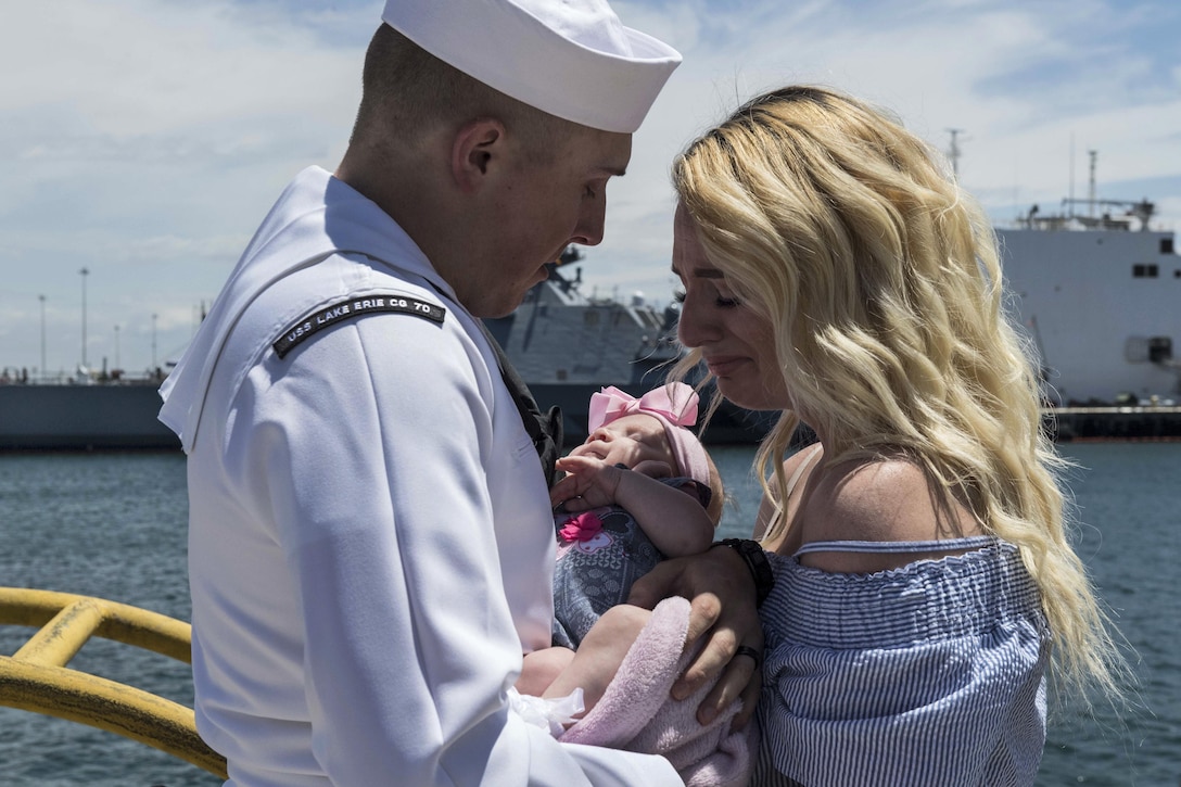 Navy Petty Officer 2nd Class Dylan Bagdasarian says goodbye to his wife and daughter in San Diego, May 8, 2017, before setting off on a scheduled deployment to the U.S. 7th Fleet and U.S. 5th Fleet areas of responsibility aboard the USS Lake Erie. Navy photo by Seaman Lucas T. Hans