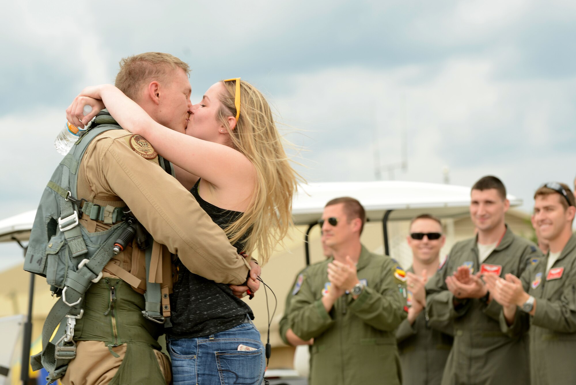 A U.S. Airman assigned to the 79th Fighter Squadron kisses his spouse after returning to Shaw Air Force Base, S.C., May 4, 2017. Airmen returned after a six-month deployment to the U.S. Central Command area of responsibility. (U.S. Air Force photo by Airman 1st Class Kathryn R.C. Reaves)