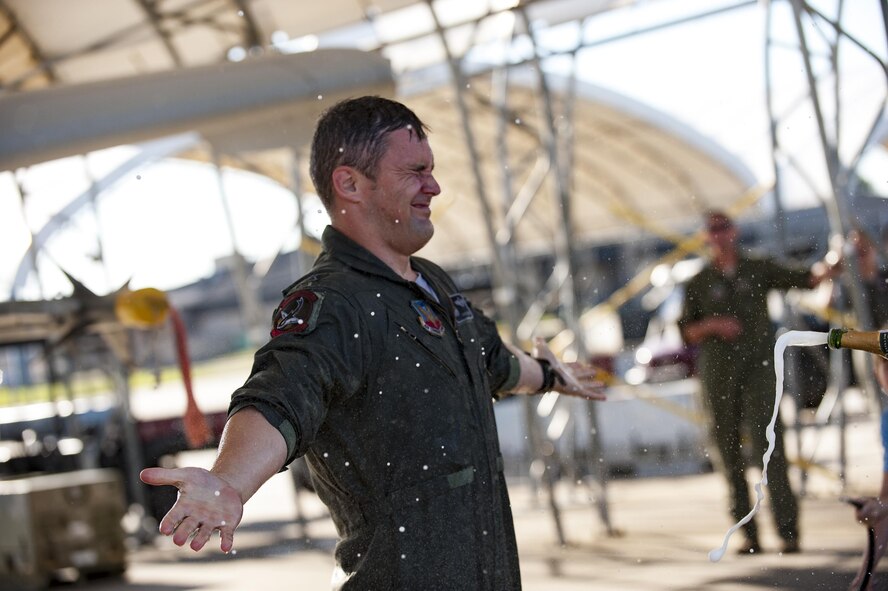 Lt. Col. Aaron “Marco” Redfern, 75th Fighter Squadron commander, is hosed down with water and champagne after his final flight as the 75th FS commander, May 8, 2017, at Moody Air Force Base, Ga. Redfern commanded the 75th FS for two years and led his pilots during the first A-10 combat deployment to Turkey in over a decade where they delivered more ordnance than any A-10 unit since Desert Storm. (U.S. Air Force photo by Andrea Jenkins) 