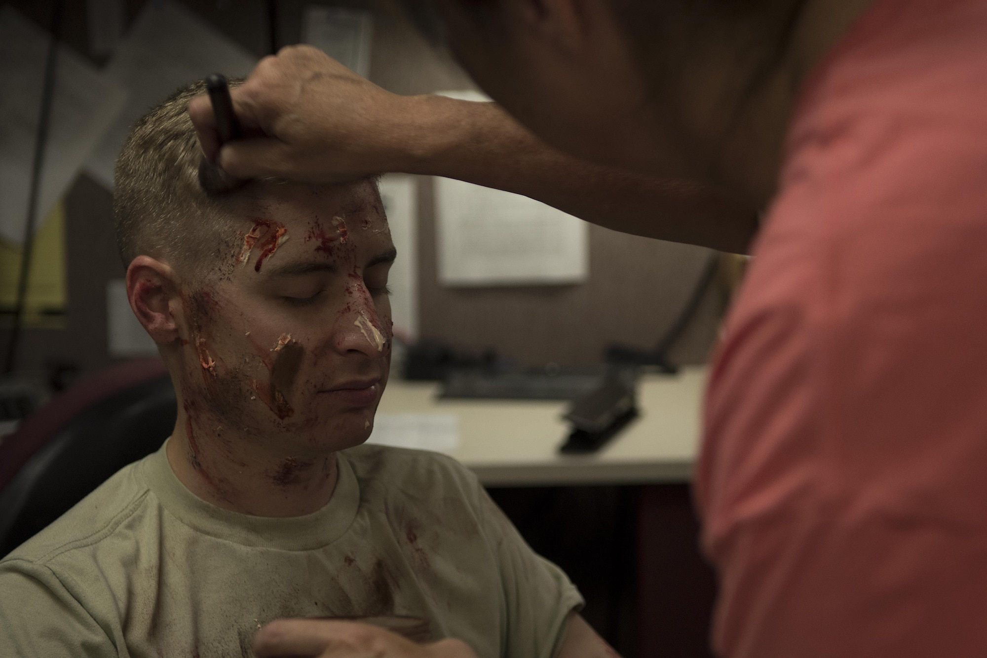 Sheila Davis, 4th Medical Group health/disease management/health care integrator (right), applies moulage to Staff Sgt. Ethan Thompson, 4th Aircraft Maintenance Squadron crew chief, who acted as a simulated victim during a Major Accident Response Exercise, May 10, 2017, at Seymour Johnson Air Force Base, North Carolina. During the exercise, members of the 4th MDG and Wayne County Emergency Medical Services exercised triage and crisis response efforts. (U.S. Air Force photo by Airman Shawna Keyes)