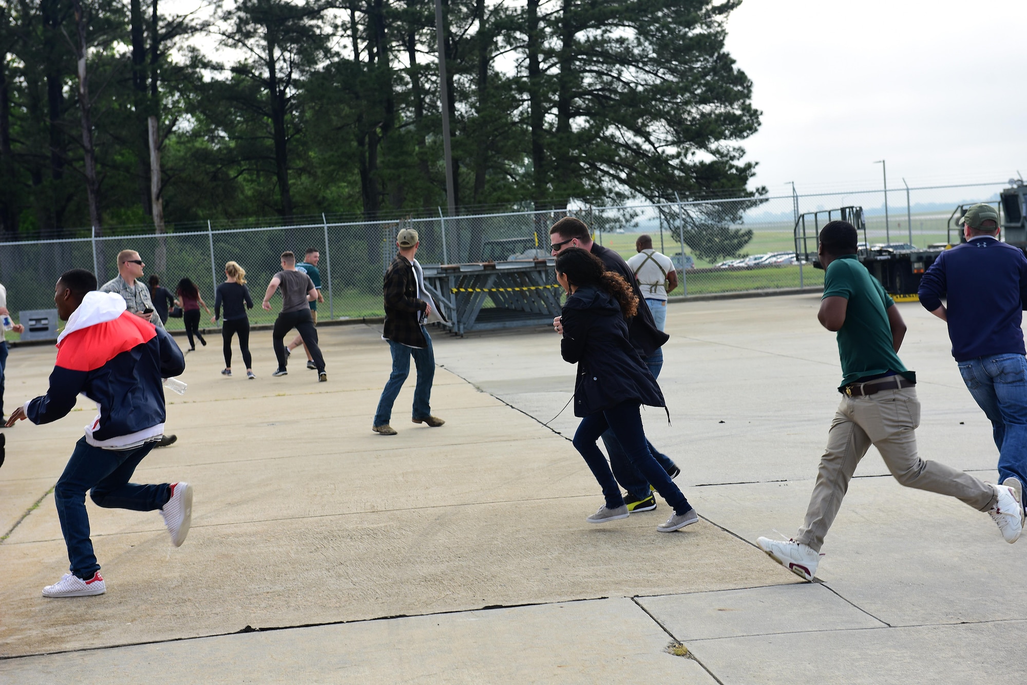 Participants run away from a simulated explosion during a Major Accident Response Exercise, May 10, 2017, at Seymour Johnson Air Force Base, North Carolina. By working together during the scenario, members of the 4th Fighter Wing and Wayne County Emergency Services trained to enhance response capabilities in the event of a real-world crisis. (U.S. Air Force photo by Airman 1st Class Kenneth Boyton)