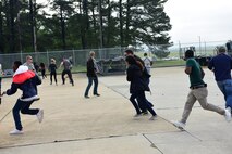 Participants run away from a simulated explosion during a Major Accident Response Exercise, May 10, 2017, at Seymour Johnson Air Force Base, North Carolina. By working together during the scenario, members of the 4th Fighter Wing and Wayne County Emergency Services trained to enhance response capabilities in the event of a real-world crisis. (U.S. Air Force photo by Airman 1st Class Kenneth Boyton)