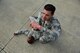 Staff Sgt. William B. Silva, 4th Civil Engineer Squadron unit deployment manager (right), calls out to emergency medical responders to help Airman 1st Class Mark Mugo, 4th Civil Engineer Squadron operations management technician, during a Major Accident Response Exercise, May 10, 2017, at Seymour Johnson Air Force Base, North Carolina. Mugo simulated injuries to test and improve first responders’ capabilities. (U.S. Air Force photo by Airman 1st Class Kenneth Boyton)