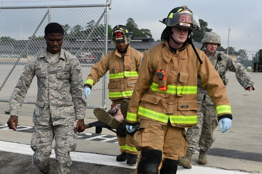 Sheila Davis, 4th Medical Group health/disease management/health care integrator (right), applies moulage to Staff Sgt. Ethan Thompson, 4th Aircraft Maintenance Squadron crew chief, who acted as a simulated victim during a Major Accident Response Exercise, May 10, 2017, at Seymour Johnson Air Force Base, North Carolina. During the exercise, members of the 4th MDG and Wayne County Emergency Medical Services exercised triage and crisis response efforts. (U.S. Air Force photo by Airman Shawna Keyes)