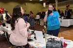 An attendee of the Joint Base San Antonio-Lackland Military & Family Readiness Center Military Spouse Appreciation Event samples products May 4 , 2017, at JBSA-Lackland, Texas. The staff of the M&FRC at JBSA –Lackland hosted the event to honor military spouses and provide a platform for spouses who are entrepreneurs to showcase their businesses. (U.S. Air Force photo by Staff Sgt. Marissa Garner) 