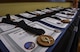 Certificates and medallions sit on display at Air Force Special Operations Command’s 2016 Outstanding Airmen of the Year at Hurlburt Field, Fla., May 10, 2017. AFSOC formally recognized its outstanding Airmen of the year with a weeklong tour of Hurlburt Field. (U.S. Air Force photo by Airman 1st Class Joseph Pick)
