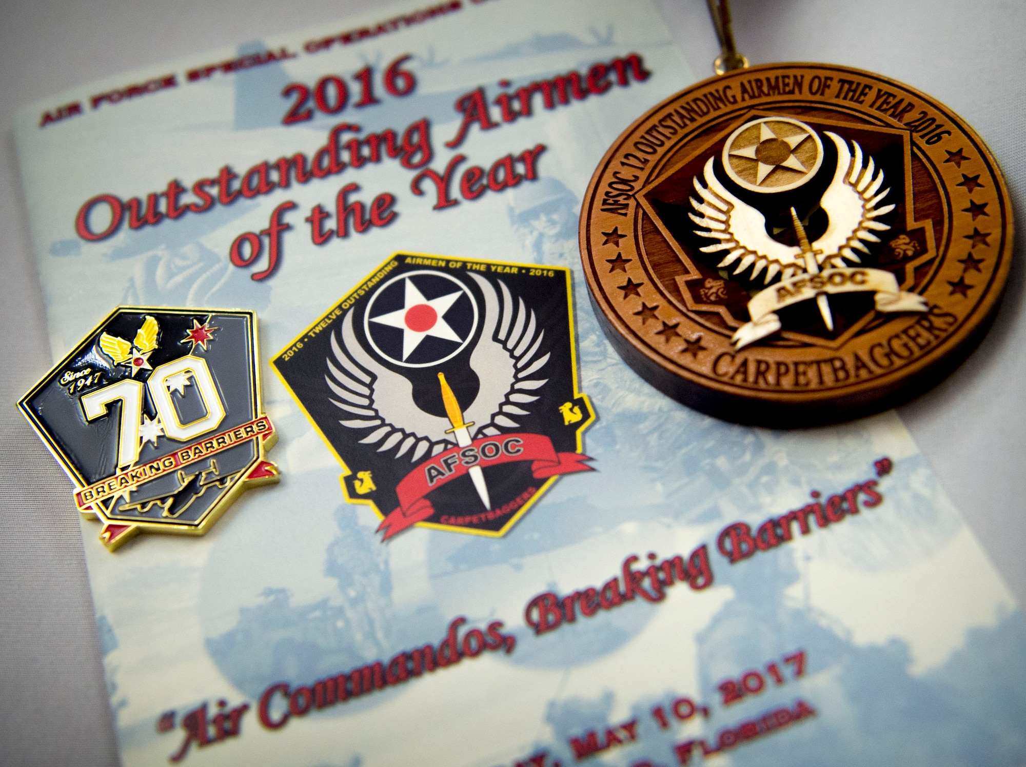A program, pin and medallion are displayed at Air Force Special Operations Command’s 2016 Outstanding Airmen of the Year banquet at Hurlburt Field, Fla., May 10, 2017. AFSOC formally recognized its outstanding Airmen of the year with a weeklong tour of Hurlburt Field. (U.S. Air Force photo by Senior Airman Krystal M. Garrett)