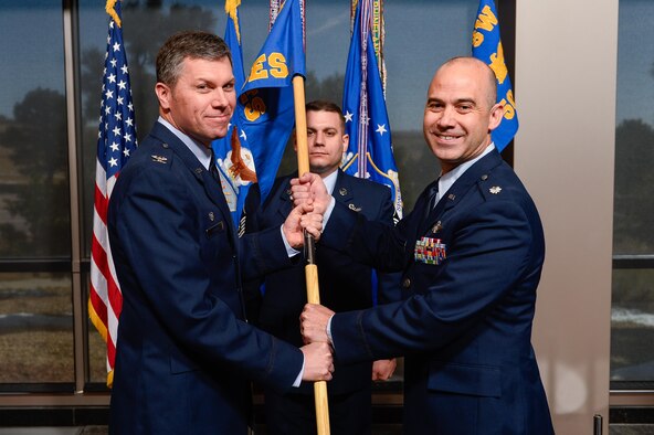 Col. Toby Doran, 50th Operations Group commander, presents the 3rd Space Experimentation Squadron guidon to Lt. Col. Kevin Amsden during the squadron’s change of command ceremony at Schriever Air Force Base, Colorado, April 6, 2017. Benson assumed command of the squadron from Lt. Col. Zachary Owen. (U.S. Air Force photo/Chris DeWitt) 