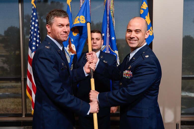 Col. Toby Doran, 50th Operations Group commander, presents the 3rd Space Experimentation Squadron guidon to Lt. Col. Kevin Amsden during the squadron’s change of command ceremony at Schriever Air Force Base, Colorado, April 6, 2017. Benson assumed command of the squadron from Lt. Col. Zachary Owen. (U.S. Air Force photo/Chris DeWitt) 