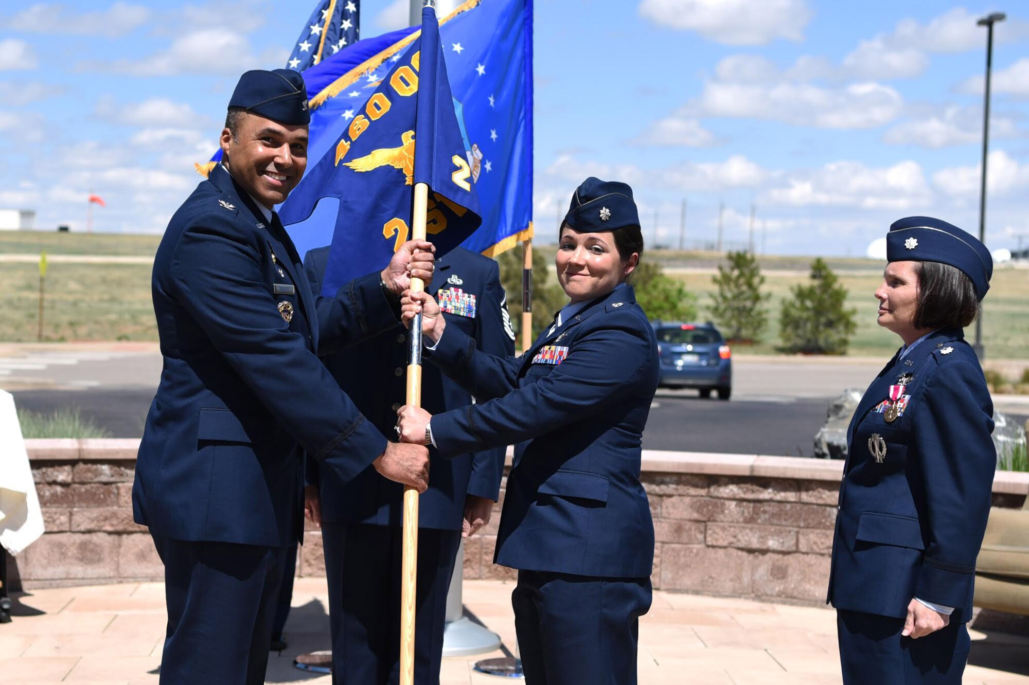 Col. Lorenzo Bradley, 460th Operations Group commander, hands the 2nd Space Warning Squadron guidon to Lt. Col. Shannon DaSilva, 2nd SWS commander, May 11, 2017, on Buckley Air Force Base, Colo.  Shannon, the squadron’s new commander, is now responsible for the primary operations unit within the 460th OG. (U.S. Air Force photo by Airman 1st Class Holden S. Faul/Released)