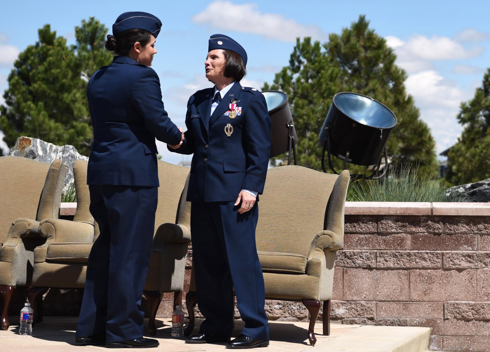 From left to right: Lt. Col. Shannon DaSilva, 2nd Space Warning Squadron commander, shares words with Lt. Col. April Wimmer, 2nd SWS parting commander, after their change of command ceremony May 11, 2017. At Buckley Air Force Base, Colo. Shannon is now responsible for the primary operations unit within the 460th OG, which continues to operate a more than 40-year-old, $3.2 billion on-orbit Defense Support Program satellite constellation. (U.S. Air Force photo by Airman 1st Class Holden S. Faul/Released)