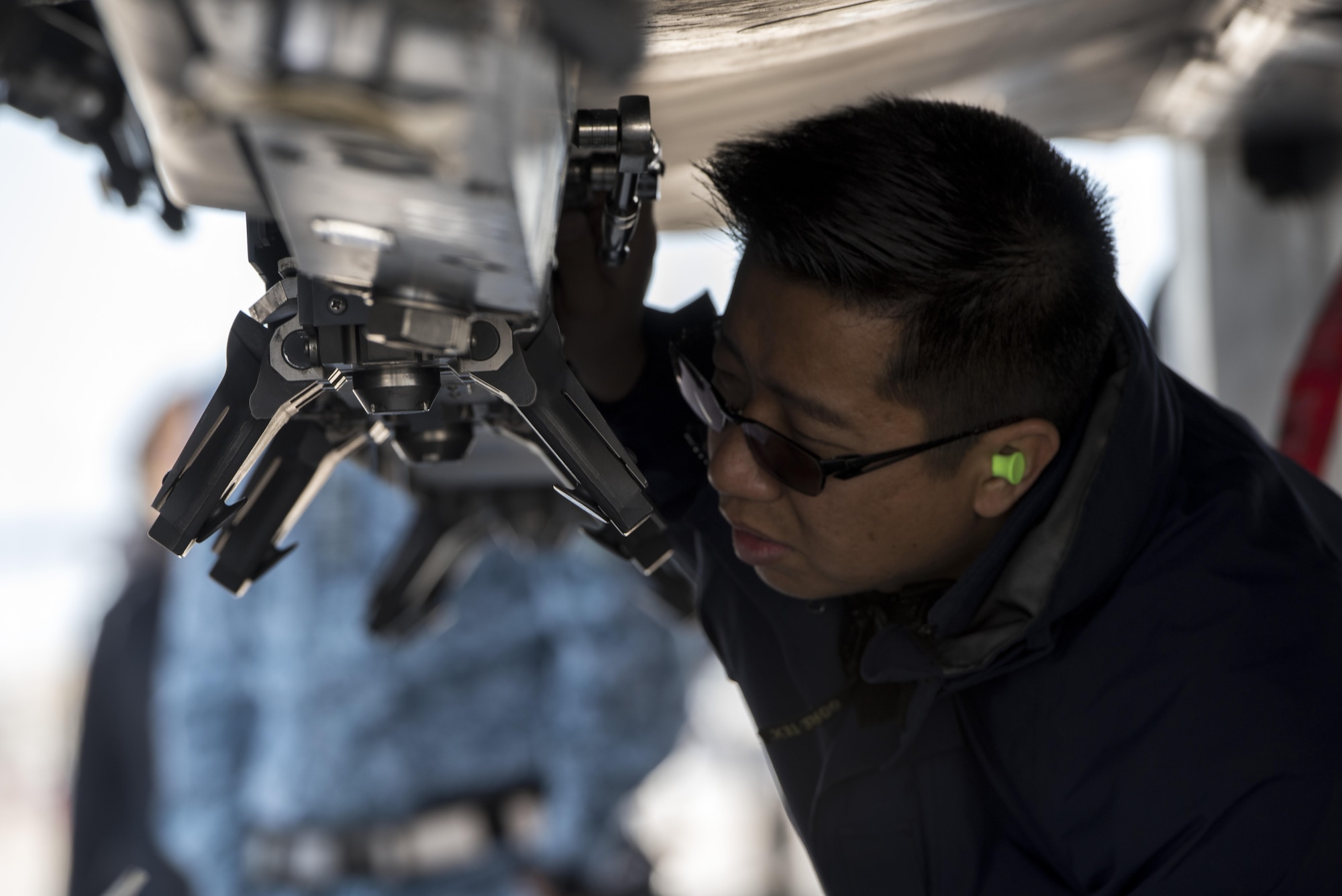 A member of the Republic of Singapore Air Force inspects an F-15SG May 1, 2017, at Mountain Home Air Force Base, Idaho. Every tiny piece of the jet must be looked over multiple times to ensure everything is perfect. (U.S. Air Force photo by Senior Airman Jeremy L. Mosier/Released)