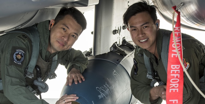 Republic of Singapore Lt. Col. Oon Kok Choon, 428th Fighter Squadron senior ranking officer, left, and RSAF Lt. Eng Jun Chao, 428th FS weapons system operator, right, pose for a photo before heading to Combat Hammer, May 2, 2017, at Mountain Home Air Force Base, Idaho. RSAF flight crew spent the week testing their weapons system capabilities during Combat Hammer.(U.S. Air Force photo by Senior Airman Jeremy L. Mosier/Released)