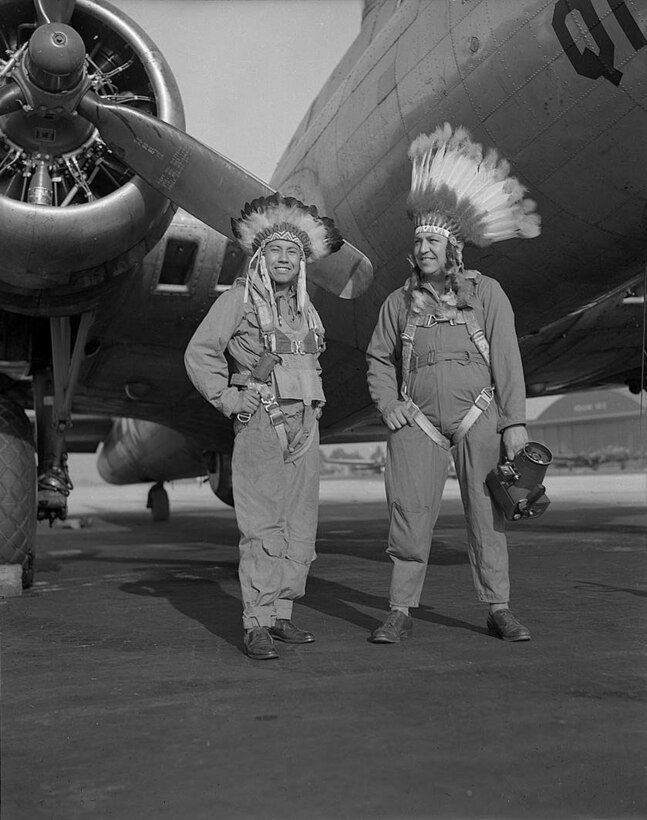 B-17 Flying Fortress crewmembers Gus Palmer, a citizen of the Kiowa nation and a side gunner, and Horace Poolaw, also a Kiowa and an aerial photographer, stand near their aircraft at MacDill Field, Fla., in about 1944.  This photo is in the exhibition “For a Love of His People: The Photography of Horace Poolaw,” on the third floor of the National Museum of the American Indian. Photo courtesy of the estate of Horace Poolaw and the National Museum of the American Indian