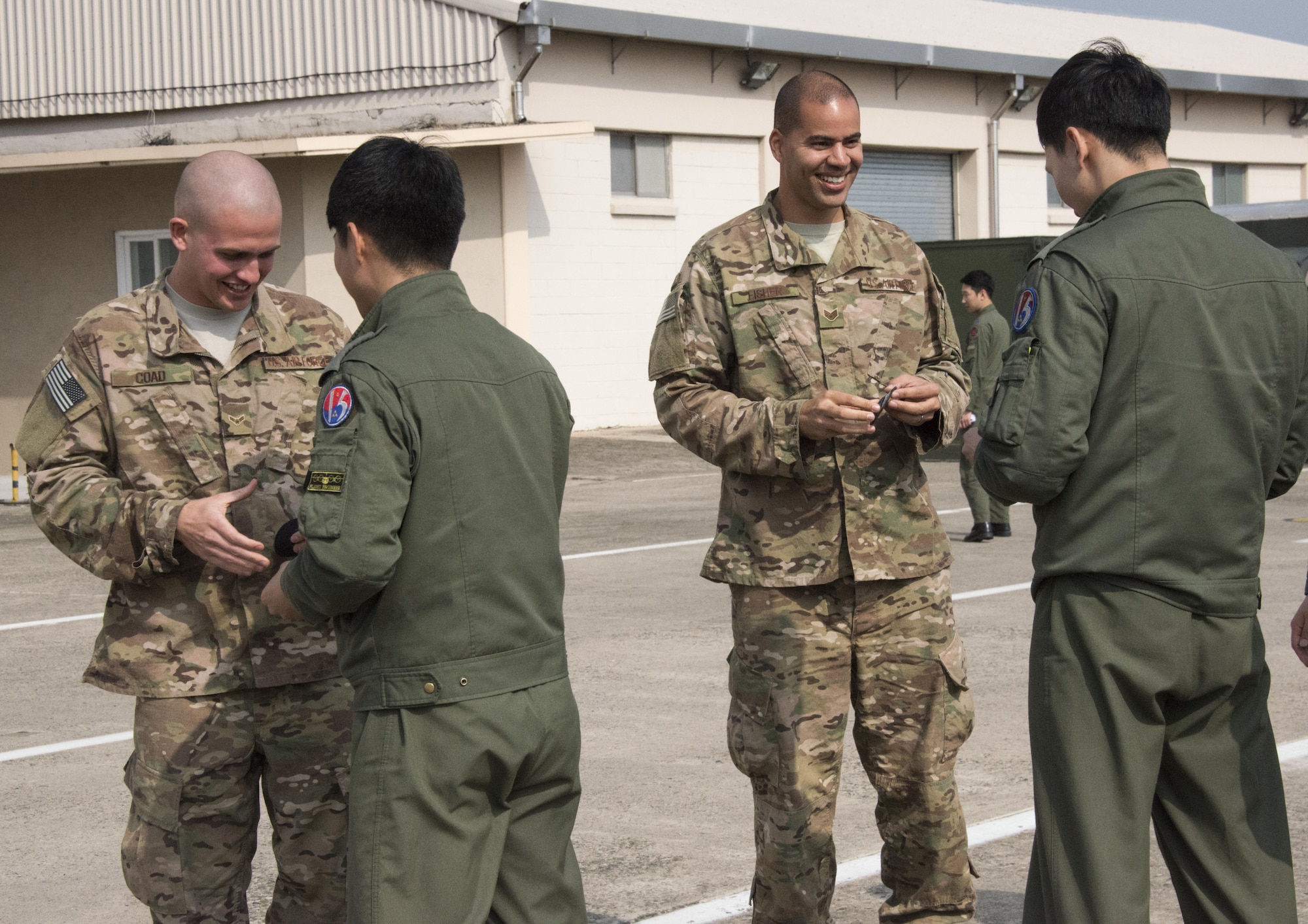 U.S. Air Force 353rd Special Operations Support Squadron radio frequency technicians exchange patches with members of the Republic of Korea 255th Special Operations Squadron following a radio capability discussion on a ROK Air Force C-130, March 29, 2017 at Daegu Air Base, ROK. Throughout Foal Eagle 2017, the 353rd SOG and 255th SOS demonstrated the strength of a partnership that has evolved over the years. (U.S. Air Force photo by Capt. Jessica Tait)