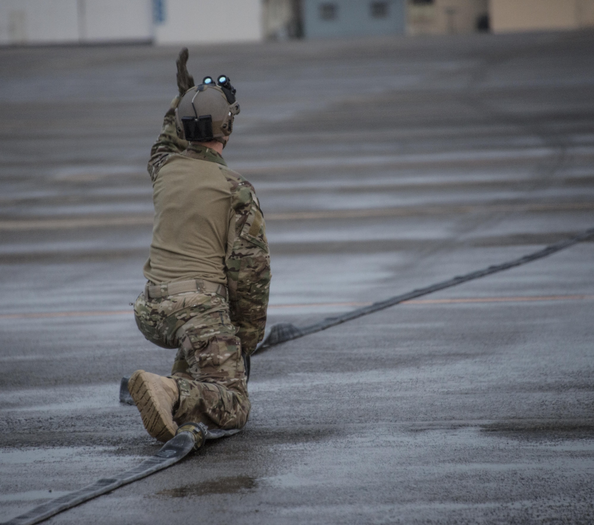 A U.S. Air Force 18th Logistics Readiness Squadron forward area refueling point (FARP) technician communicates with his team during a FARP operation from a U.S. Air Force MC-130J Commando II assigned to the 17th Special Operations Squadron, April 1, 2017 at Daegu Air Base, Republic of Korea. The FARP team provides covert and nighttime refueling operations in situations where traditional refueling capabilities are not feasible. (U.S. Air Force photo by Capt. Jessica Tait)