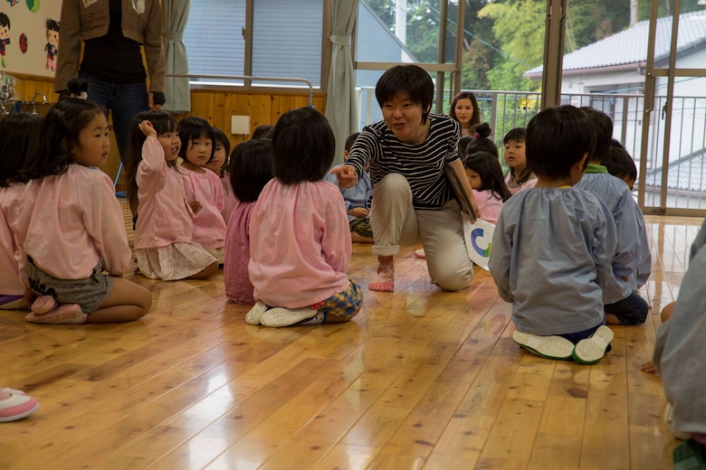 Shiori Minato, an administration specialist with the Marine Memorial Chapel, counts groups of Josho Hoikuen Preschool students during a community relations event in Iwakuni City, Japan, May 9, 2017. Volunteering at the preschool helped the relationship between Marine Corps Air Station Iwakuni residents and the local community grow stronger. Introductions were given by the volunteers while students asked them questions, then the children were introduced to “The Hokey Pokey” and “Head, Shoulders, Knees and Toes” before playing educational games with the volunteers. (U.S. Marine Corps photo by Lance Cpl. Gabriela Garcia-Herrera)