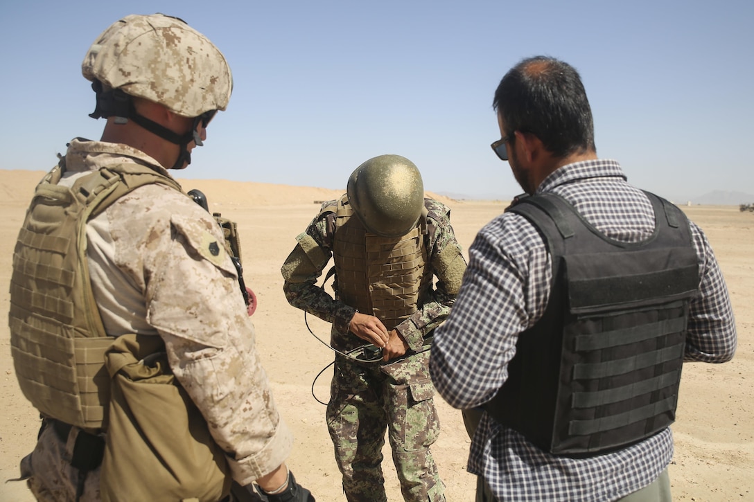 A U.S. Marine with Task Force Southwest observes as an Afghan National Army soldier with the 215th Corps ties detonation cord to a block of C-4 at Camp Shorabak, Afghanistan, May 10, 2017. More than 20 ANA soldiers are executing explosive hazard reduction training with assistance from Marines and Sailors with TFSW. The unit is comprised of approximately 300 service members, whose mission is to train, advise and assist the ANA 215th Corps and 505th Zone National Police. (U.S. Marine Corps photo by Sgt. Lucas Hopkins)