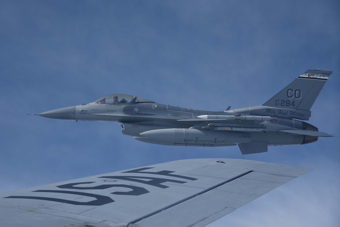 An F-16 Fighting Falcon assigned to the 120th Fighter Squadron, Colorado Air National Guard, flies near the wing of a KC-135 Stratotanker assigned to McConnell Air Force Base, Kan. after being refueled May 10, 2017, over Colorado. Aerial refueling allows aircraft to fly for longer periods of time without needing to land to refuel. (U.S. Air Force photo/Airman 1st Class Erin McClellan)