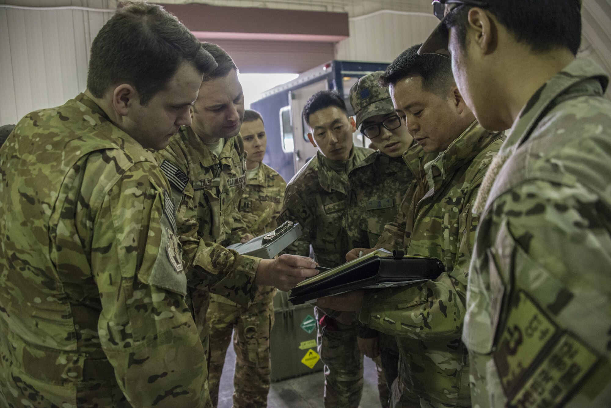 U.S. Air Force 17th Special Operations Squadron aircrew and 320th Special Tactics Squadron combat controllers meet with counterparts from the Republic of Korea 255th Special Operations Squadron to discuss military free fall operations, March 24, 2017 at Daegu Air Base, ROK. Foal Eagle 2017 provided the opportunity at further developing interoperability with counterparts from the ROK military through daily airborne operations to include military free fall and static line drops. (U.S. Air Force photo by Capt. Jessica Tait)