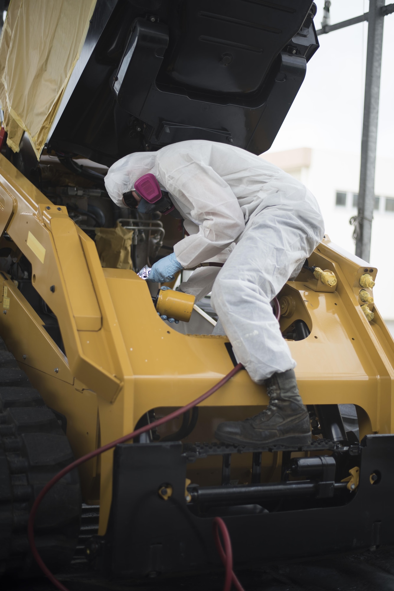 A U.S. Air Force Airman from the 18th Logistics Readiness Squadron applies anti-corrosion chemicals April 6, 2017, at Kadena Air Base, Japan. The product provides a thin layer of protection over bare metal or painted surfaces so the vehicle can resist corrosion, effectively reducing the amount of corrosion sustained and maintaining mission effectiveness for longer periods of time. (U.S. Air Force photo by Senior Airman Omari Bernard)