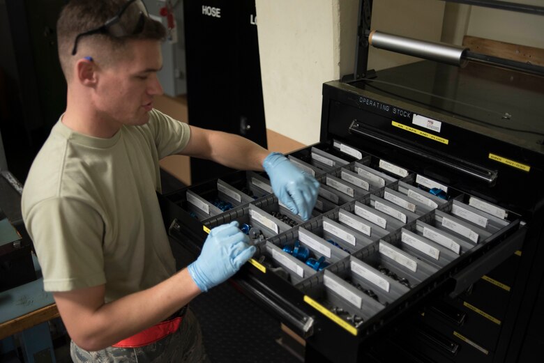 U.S. Air Force Senior Airman Joshua Cox, 18th Component Maintenance Squadron hydraulics technician, retrieves aircraft components May 2, 2017, at Kadena Air Base, Japan. Attention to detail skills are vital in order for Airmen to maintain proper accountability and handling of parts and tools. (U.S. Air Force photo by Senior Airman John Linzmeier)
