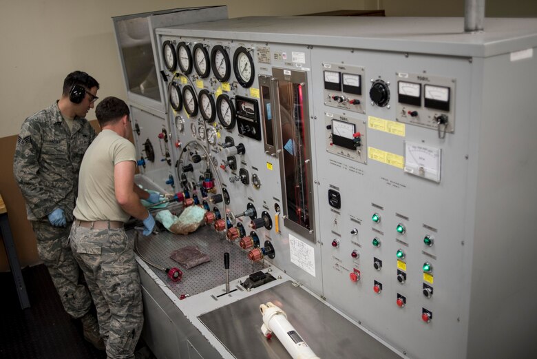 U.S. Air Force hydraulics technicians from the 18th Component Maintenance Squadron hydraulics back shop use a hydraulic test stand May 2, 2017, at Kadena Air Base, Japan. Before items are sent back to the flightline, they are raun through a series of tests that simulate the same conditions likely to occur in-flight. (U.S. Air Force photo by Senior Airman John Linzmeier)