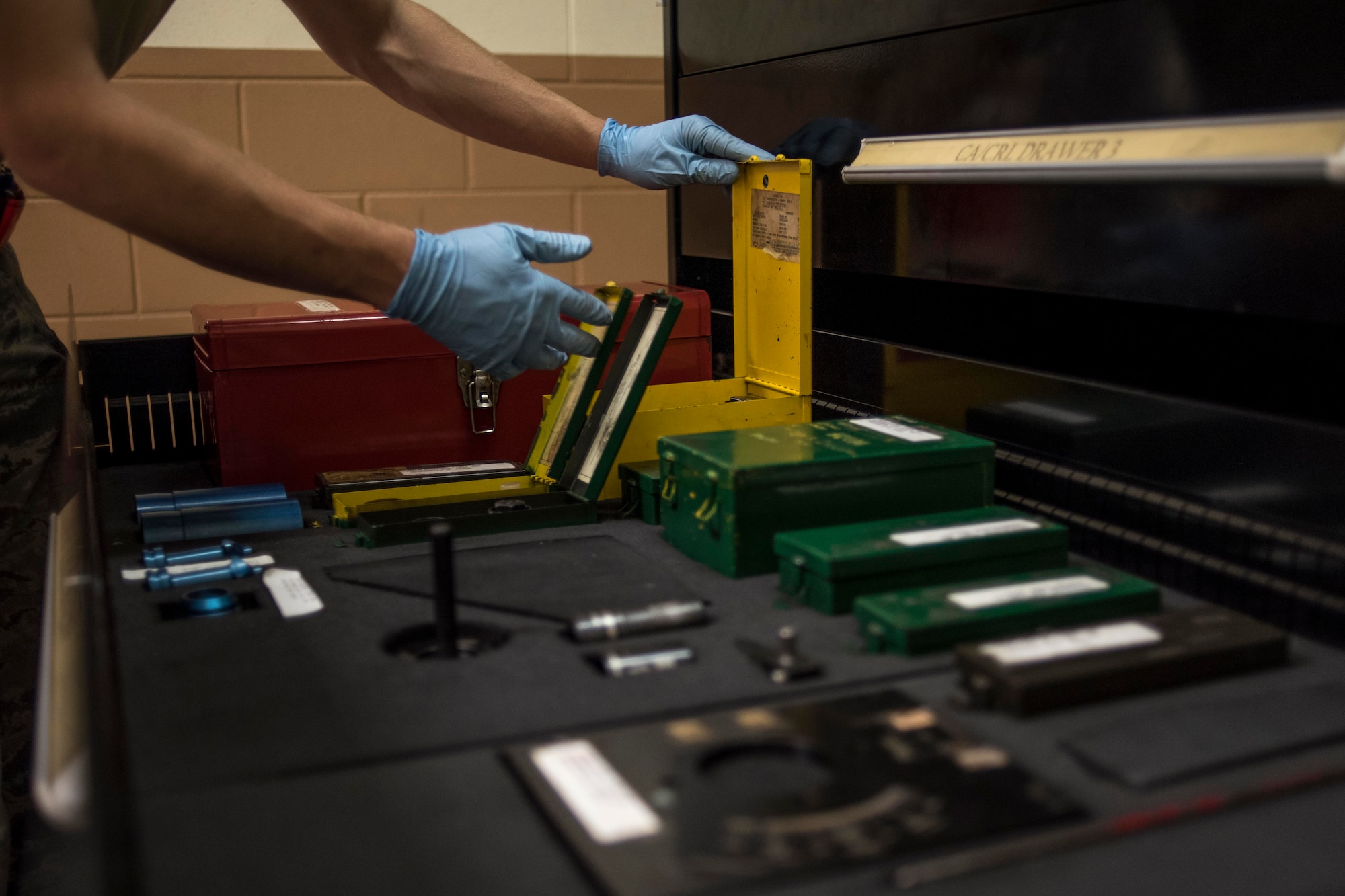 A U.S. Air Force hydraulics technician from the 18th Component Maintenance Squadron inspects a toolbox full of fitting kits May 2, 2017, at Kadena Air Base, Japan. Some of the repairs that are done in the hydraulic backshop are highly technical and often require the teamwork of several technicians to complete. (U.S. Air Force photo by Senior Airman John Linzmeier)