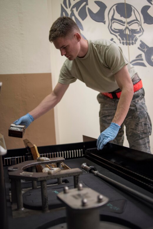 U.S. Air Force Senior Airman Joshua Cox, 18th Component Maintenance Squadron hydraulics technician, inspects brake assembly fixtures May 2, 2017, at Kadena Air Base, Japan. Brake parts are inspected for wear and corrosion, cleaned and then reassembled and tested before reattachment to the F-15 Eagle. (U.S. Air Force photo by Senior Airman John Linzmeier)