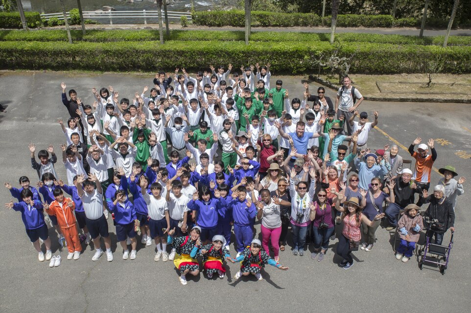 Marine Corps Air Station Iwakuni residents pose alongside Japanese students and locals duing a Cultural Adaption Program tea harvesting event in Iwakuni City, May 2, 2017. The Cultural Adaptation Program gave station residents the opportunity to experience the Japanese culture alongside elementary and high school students, nursing home residents and other Japanese locals. (U.S. Marine Corps photo by Lance Cpl. Carlos Jimenez)