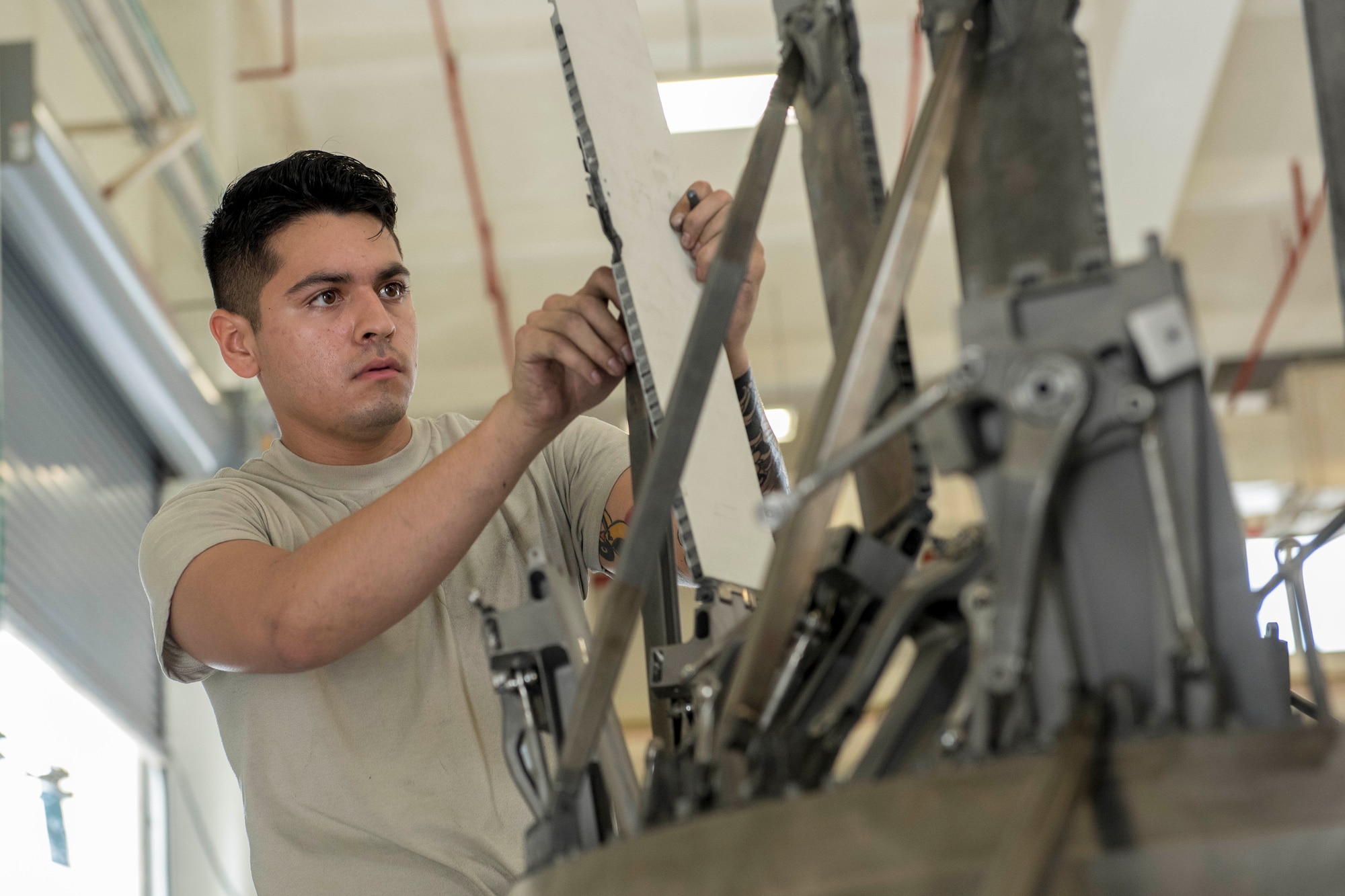 U.S. Air Force Airman 1st Class David Loveless, 18th Component Maintenance Squadron aerospace propulsion technician, services an F-15 Eagle engine augmenter May 12, 2017, at Kadena Air Base, Japan. The augmenter extends the engines thrust and allows it to break the sound barrier. (U.S. Air Force photo by Senior Airman John Linzmeier)