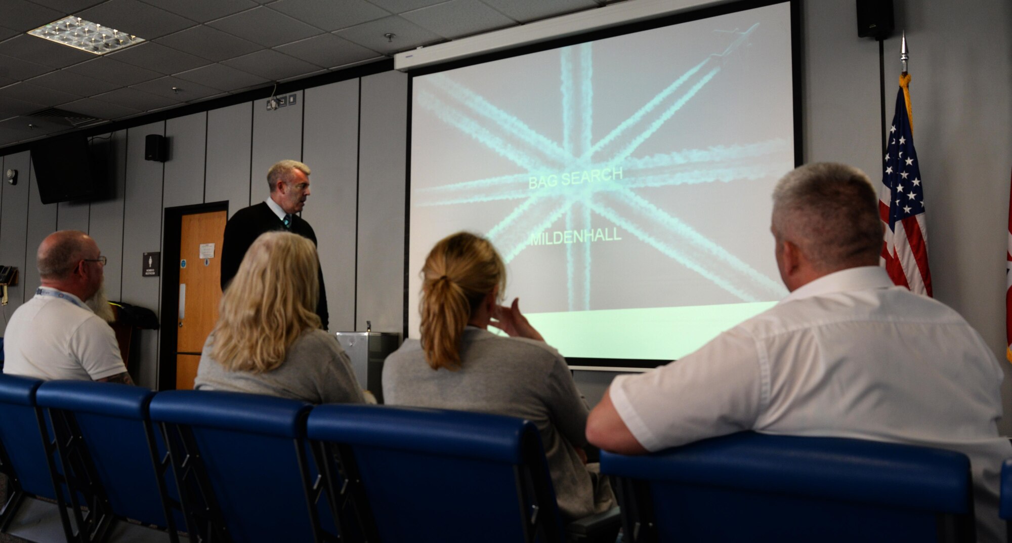 Paul Nicholls, Stansted Airport security trainer, details security check point protocol dos and don’ts May, 5, 2017, with passenger service agents assigned to the 727th Air Mobility Squadron on RAF Mildenhall, England. Passenger service agents from RAF Mildenhall organized the joint training to share knowledge and experience. Training spanned three days and was held at Stansted and RAF Mildenhall. (U.S. Air Force photo by Senior Airman Justine Rho)