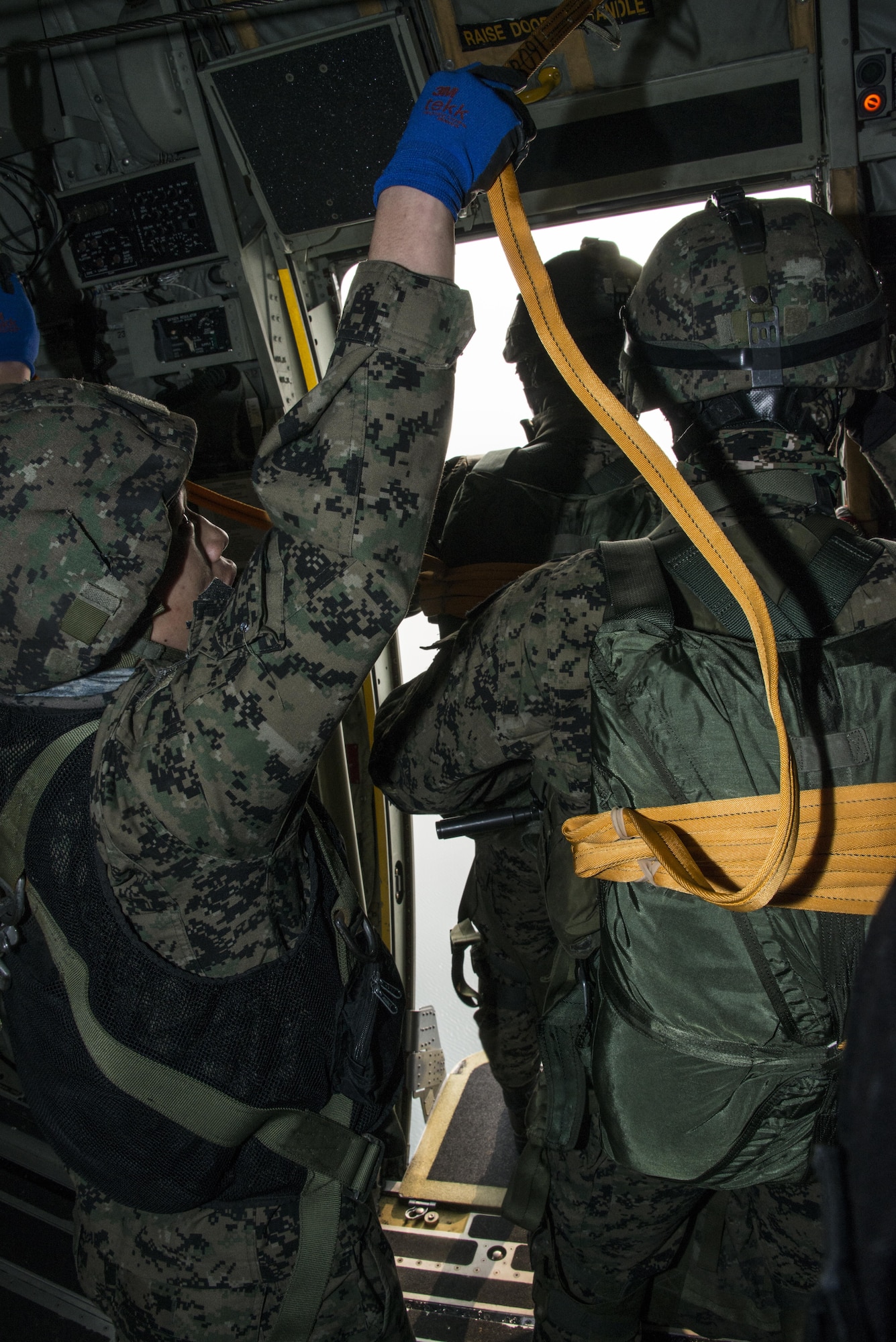 A Republic of Korea Special Warfare Command jumpmaster assists jumpers as they exit a U.S. Air Force MC-130J Commando II assigned to the 17th Special Operations Squadron during static line drop operations, March 27, 2017 at Daegu Air Base, ROK. The daily airborne operations executed during Foal Eagle 2017 further developed the integration of special operations forces and operational capability through realistic scenario-based missions. (U.S. Air Force photo by Capt. Jessica Tait)