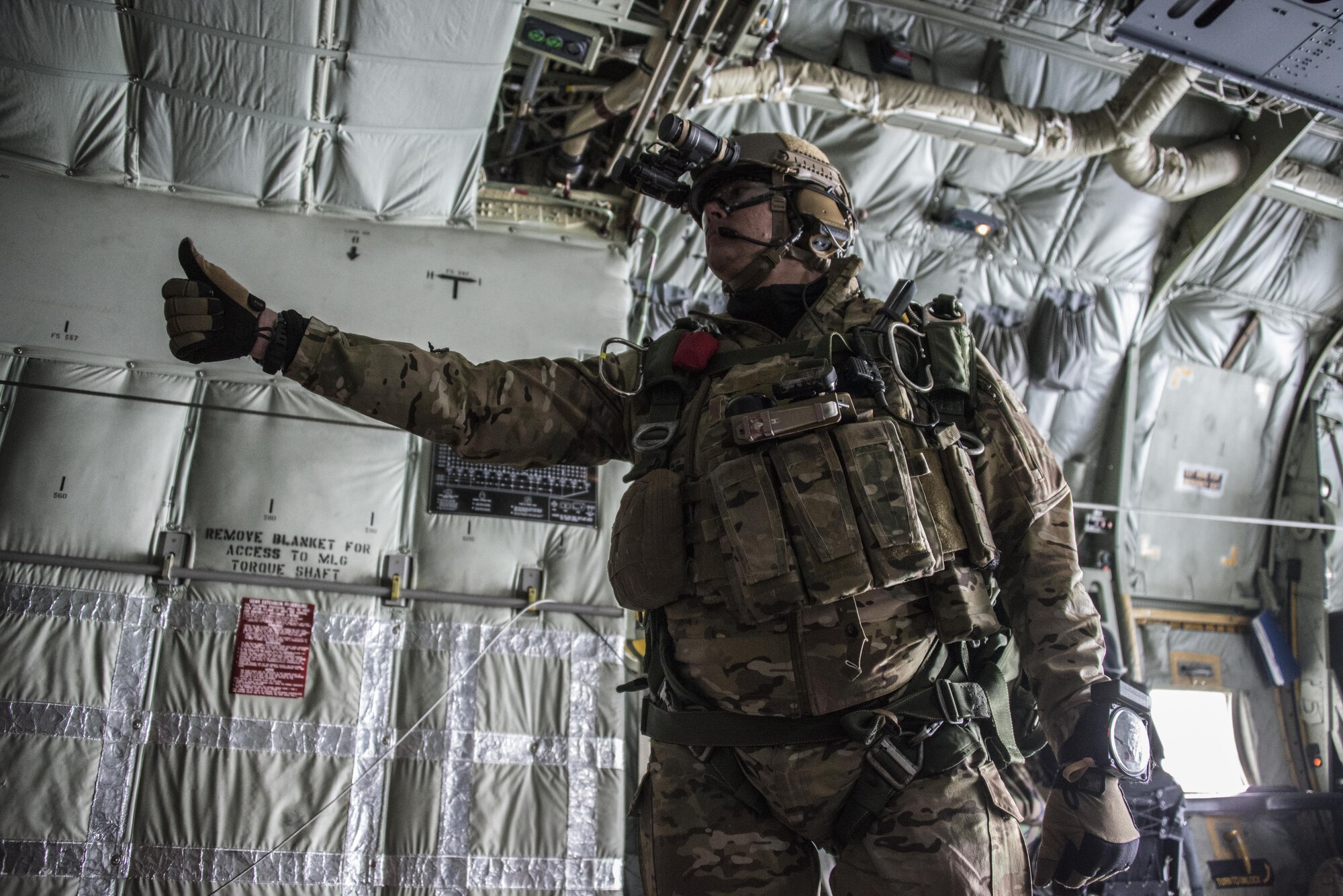 A U.S. Air Force 320th Special Tactics Squadron jumpmaster signals to jumpers prior military free fall operations from a U.S. Air Force MC-130J Commando II assigned to the 17th Special Operations Squadron, March 25, 2017 over the Republic of Korea peninsula. Foal Eagle 2017 provided an opportunity for the 320th STS to advance interoperability and increase partner capacity by planning and executing complex training missions with multiple joint and combined units. (U.S. Air Force photo by Capt. Jessica Tait)
