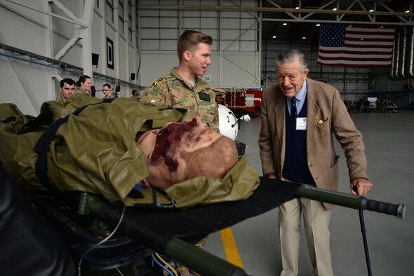 U.S. Air Force Staff Sgt. Alex Ribbens, 352nd Special Operations Support Squadron NCO in charge of special operations flight medical augmentation, shows Sir Michael Oswald, 352nd Special Operation Wing honorary commander, a dummy casualty May 9, 2017, on RAF Mildenhall, England. Honorary Commanders Day allows local leaders the opportunity to meet Airmen and see thier contribution to the Air Force mission. (U.S. Air Force photo by Senior Airman Christine Groening)