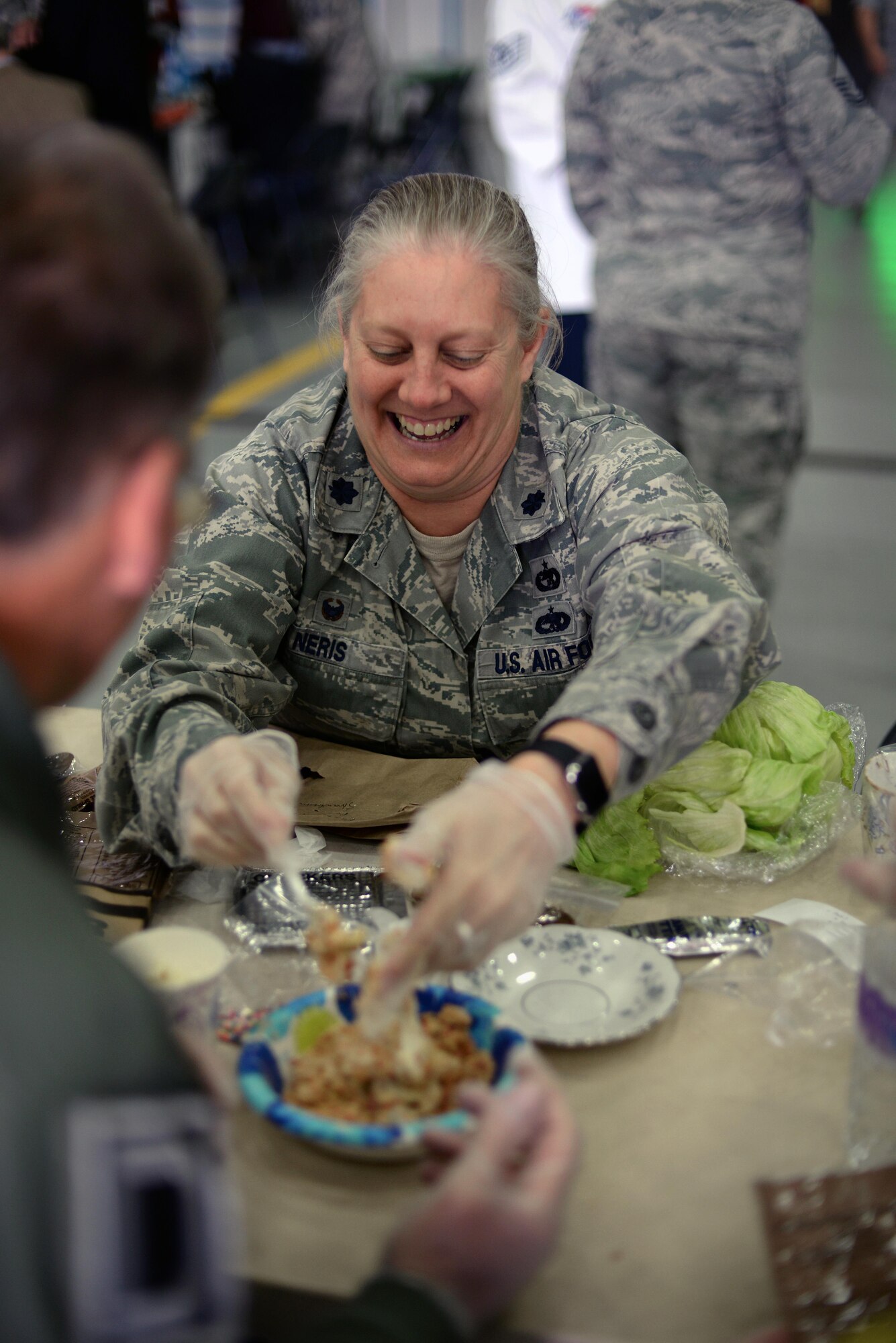 U.S. Air Force Lt. Col. Jennifer Neris, 100th Logistics Readiness Squadron commander, helps her honorary commander create a gourmet dessert during a Meal Ready to Eat Bake-off Event for Honorary Commanders’ Day, May 9, 2017, on RAF Mildenhall, England. Base leadership and their honorary commanders were tasked to create a main dish, side dish, dessert and drink with two MREs. (U.S. Air Force photo by Senior Airman Christine Groening)