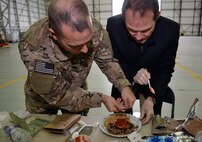 U.S. Air Force Col. Mark O’Reilly, 352nd Special Operations Maintenance Group commander, assists Rob Humphries, 352nd SOMXG honorary commander in creating a gourmet meal for a Meal Ready to Eat Bake-Off Competition for Honorary Commanders’ Day, May 9, 2017, on RAF Mildenhall, England. Base leadership and honorary commander teams create main dishes, side dishes, desserts and drinks with two MREs. (U.S. Air Force photo by Senior Airman Christine Groening)