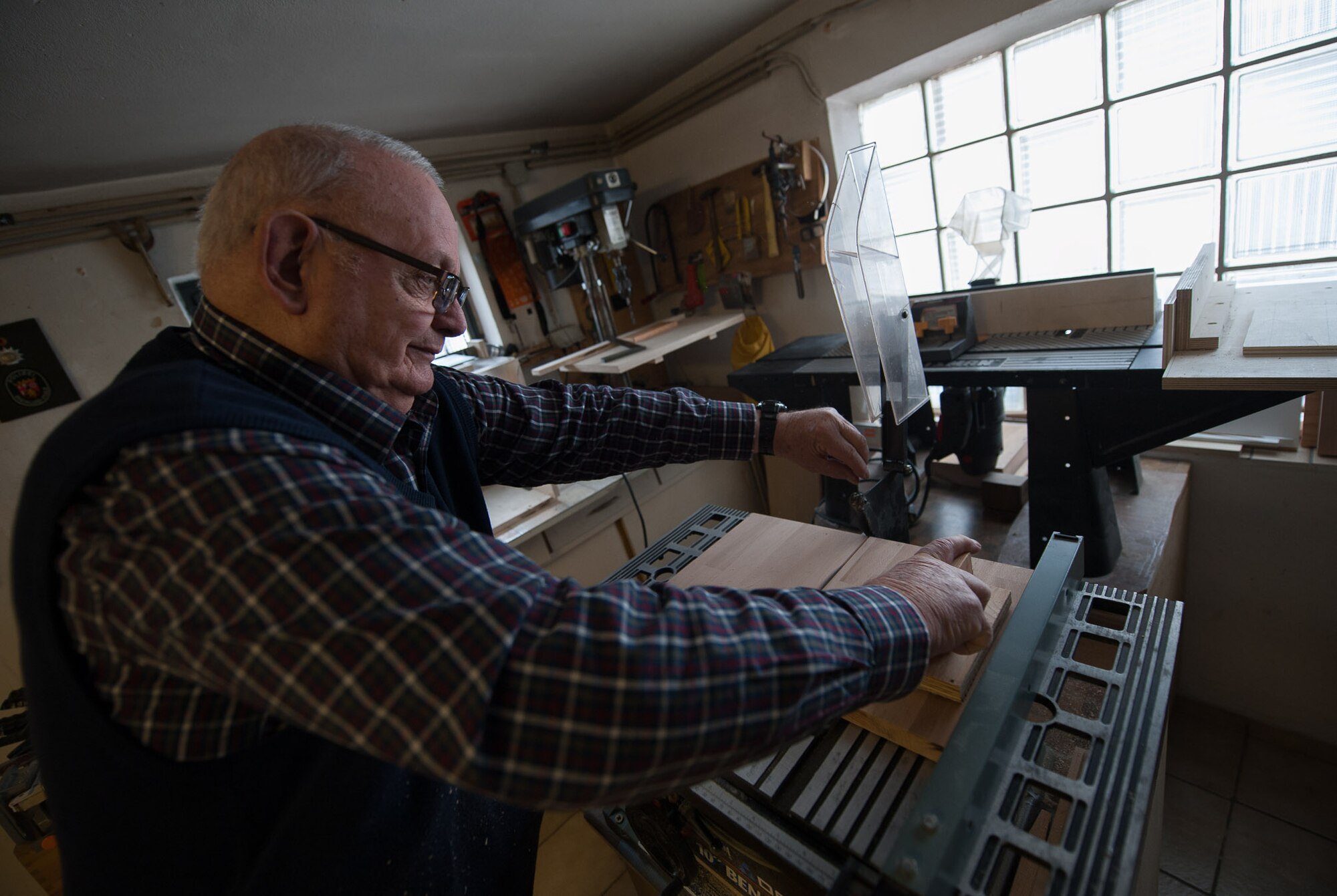 Retired Chief Master Sgt. Charles E. Milam cuts a piece of wood down the middle in his workshop in Waldfischbach-Burgalben, Germany, May 2, 2017. After serving 30 years in the U.S. Air Force, 10 years in civil service, and 20 years with the Non-Appropriated Fund (NAF) work force, Milam spends his time golfing, working in his woodshop, and visiting Ramstein Air Base. (U.S. Air Force photo by Airman 1st Class Savannah L. Waters)