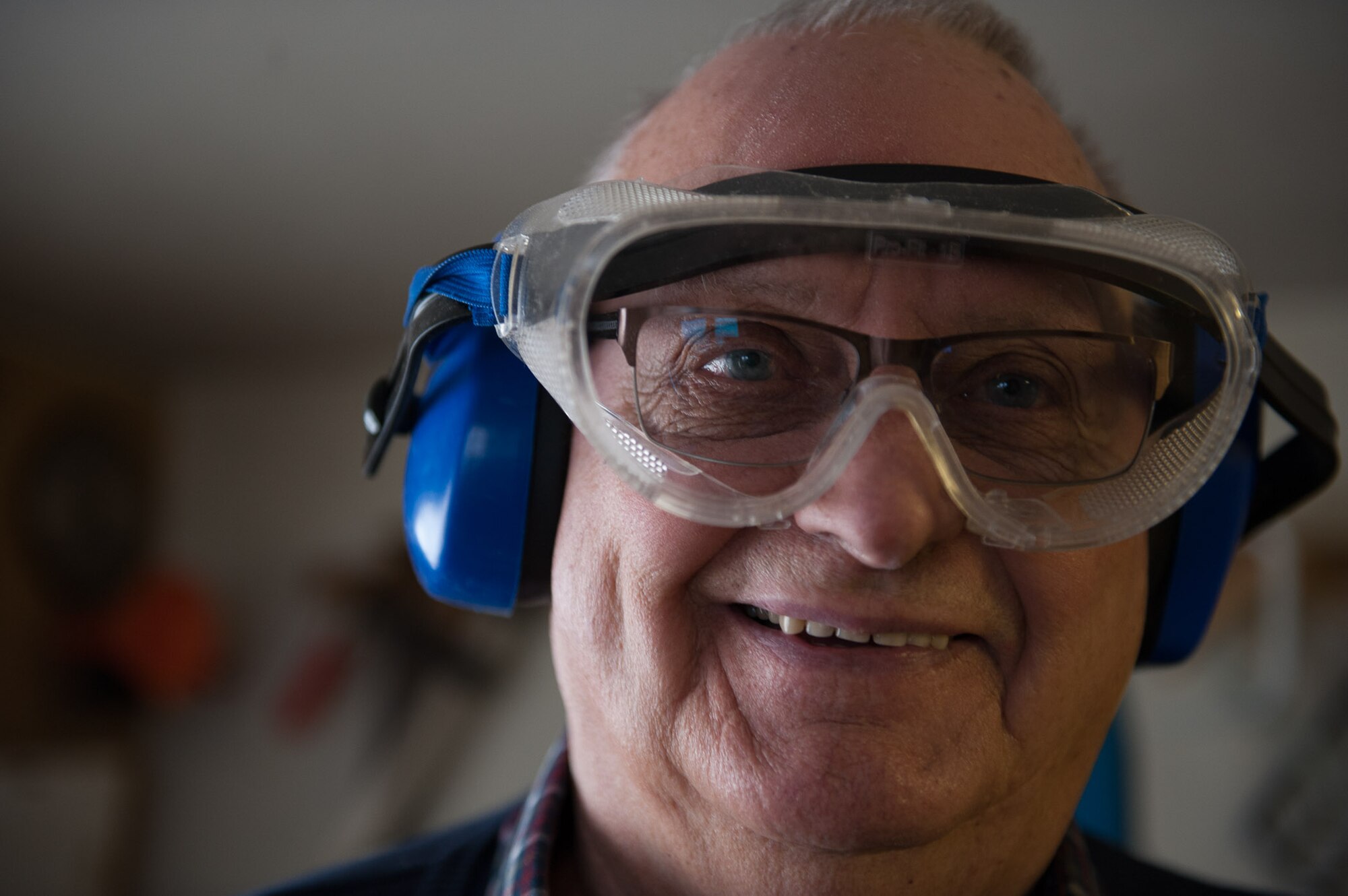 Retired Chief Master Sgt. Charles E. Milam smiles while working in his woodshop in Waldfischbach-Burgalben, Germany, May 2, 2017. During his 30 years of active-duty service, Milam was awarded the Bronze Star for his valor and meritorious service while he had administrative supervision over 11 Airmen assigned to security for the Presidential Advisor on Vietnam Affairs. He also trained Vietnamese guards who provided security for the embassy housing during his second Vietnam tour. (U.S. Air Force photo by Airman 1st Class Savannah L. Waters)