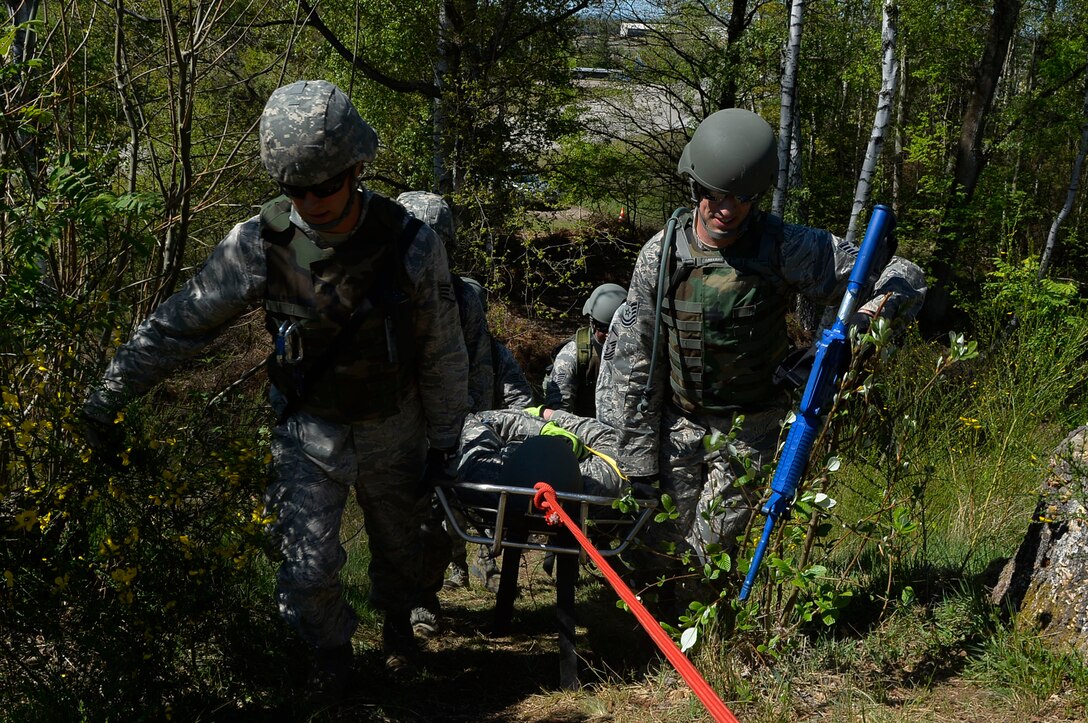 Civil engineer Airmen from various Air National Guard units recover a mock casualty during a Silver Flag exercise on Ramstein Air Base, Germany, May 10, 2017. Silver Flag is a contingency readiness exercise which involves various scenarios to prepare Airmen for being in deployed environments. (U.S. Air Force photo by Airman 1st Class Joshua Magbanua)