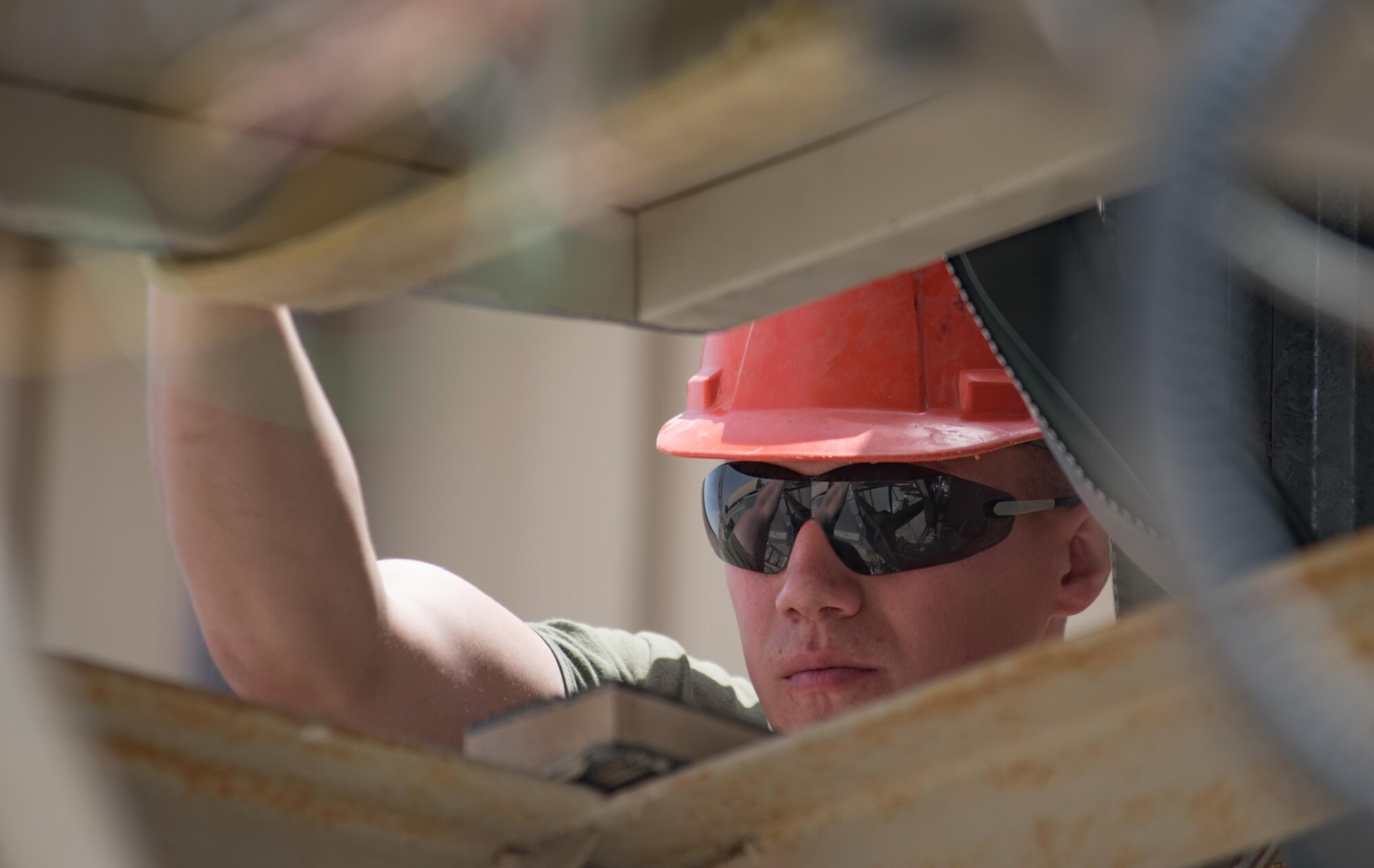 Marine Corps Sgt. Jospeh Spore, a welder with Marine Wing Support Squadron 372, top, prepares an air duct opening for the installation of a new industrial air conditioning unit while Staff Sgt. Hassan Mateyka, an HVAC technician with the 407th Expeditionary Civil Engineer Squadron, secures the ladder May 4, 2017, in Southwest Asia. Expeditionary Marines with MWSS 372 support the Group Special Purpose Marine Air-Ground Task Force-Crisis Response-Central Command, which is collocated with the 407th AEG. Marines and Airmen frequently partner to sharpen joint skillsets and complete pressing work assignments. (U.S. Air Force photo by Staff Sgt. Alexander W. Riedel)