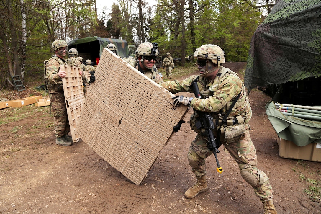 Soldiers unload a light medium tactical vehicle while establishing a tactical operations center during Saber Junction 17 at the Hohenfels Training Area, Germany, May 4, 2017. Army photo by Sgt. John Cress Jr.