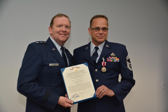 During his final commander's call, Major General Richard Scobee, Tenth Air Force Commander, presented the Meritorious Service Medal to Chief Master Sgt. Richard Ernst, Tenth Air Force Commanders Support Staff Superintendent, for outstanding service during the numbered air force transition and superior performance during the management effectiveness inspection.