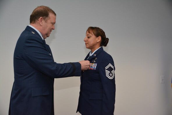 During his final commander's call, Major General Richard Scobee, Tenth Air Force Commander, presented the Meritorious Service Medal to Senior Master Sgt. Vickie Speece, Tenth Air Force Unit Training Superintendent, for outstanding achievement in support of ongoing contingency operations.