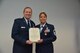 During his final commander's call, Major General Richard Scobee, Tenth Air Force Commander, presented the Meritorious Service Medal to Senior Master Sgt. Vickie Speece, Tenth Air Force Unit Training Superintendent, for outstanding achievement in support of ongoing contingency operations.