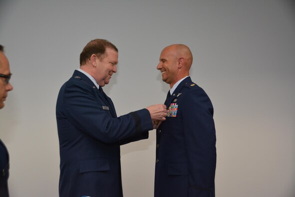 During his final commander's call, Major General Richard Scobee, Tenth Air Force Commander, presented the Aerial Achievement Medal to Major Brandon McRay, Tenth Air Force Remotely Piloted Aircraft Staff Training Officer, for aerial accomplishments in support of ongoing contingency operations.